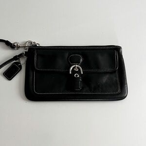 Coach black wristlet zip closure and outside pocket.